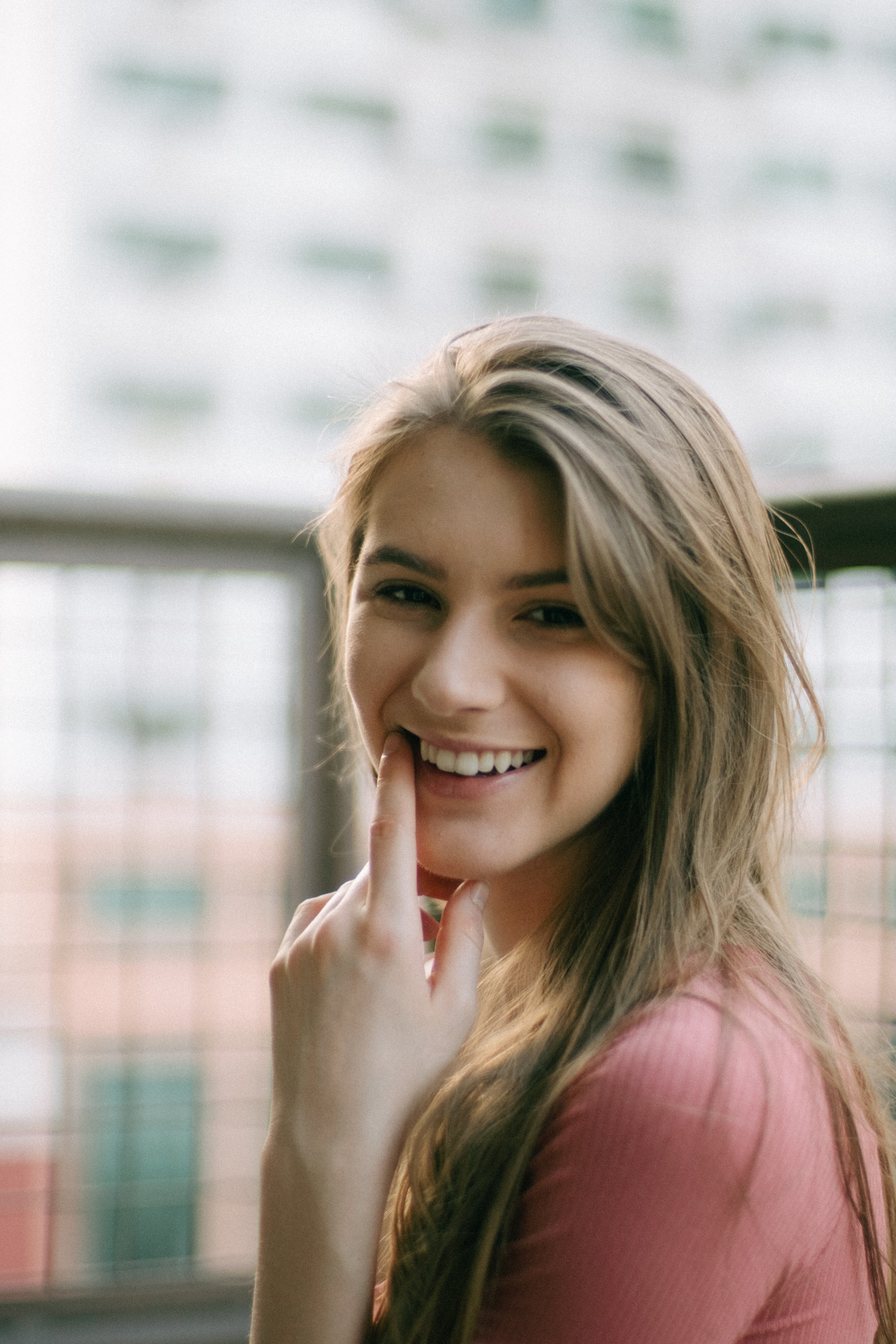 Girl grins and points to her smile after cavity removal in Mission, BC