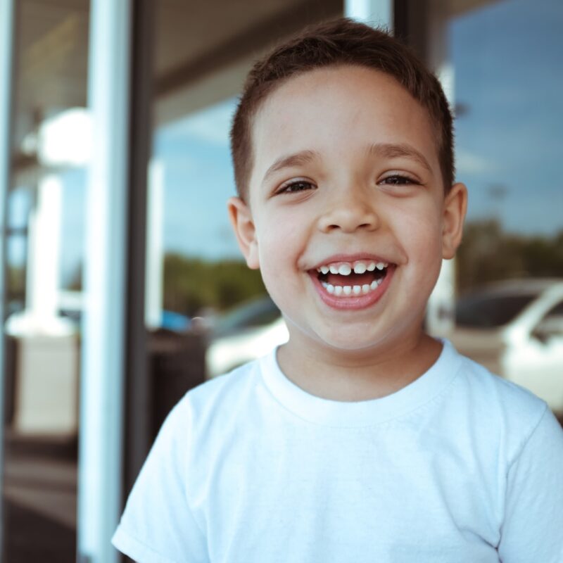 happy young boy in white tshirt
