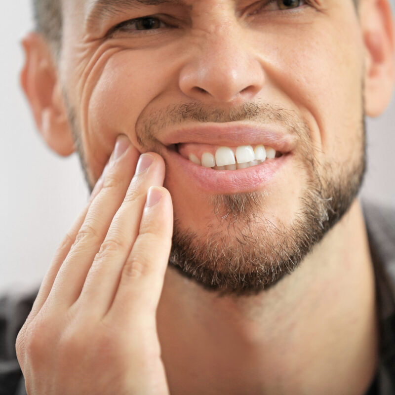 man with tooth pain needs cavity removal