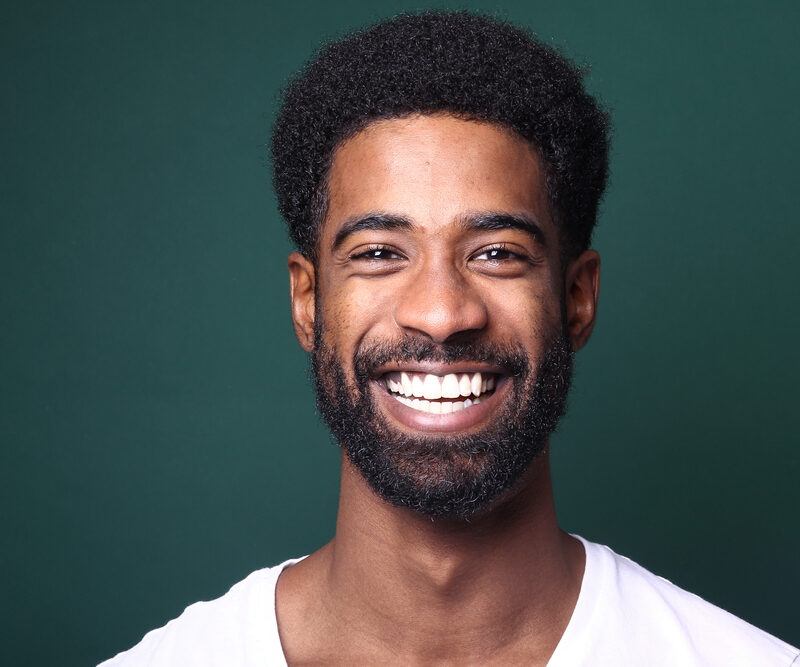 Portrait of a beautiful happy man in front of a colored background. High quality photo
