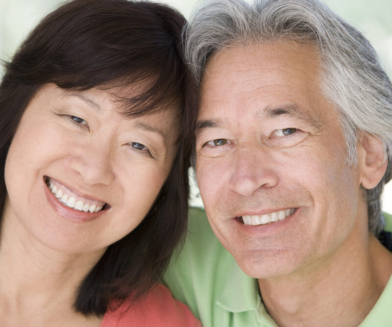 middle-aged asian couple smiling