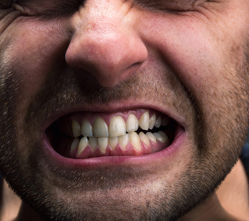 close up of man grinding his teeth