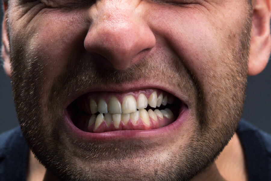 close up of man grinding his teeth